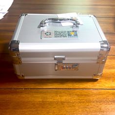 a silver suitcase sitting on top of a wooden floor