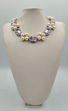 Each piece of our statement necklaces is handmade and one of a kind made in Italy. Our creations is made of high quality materials such as crystals and rhinestones. Each embroidered material is carefully hand sewn. Very glamorous and stylish. Perfect gift to someone you like. Materials Strass stones in  Violet color and White pearls.  Black eco leather backing. Aluminium color hook closure. Measurements Weight approximate 150 grams. Circumference approximate 59 cm - 23,22 in Feel free to contact us if you have any question. Thank you so much for looking at our shop and our articles each of them, single piece. Elegant Handmade Crystal Rhinestone Necklace, Elegant Crystal Beaded Necklaces With Stones, Elegant Party Beaded Necklaces With Stones, Elegant Beaded Necklaces With Stones For Party, Handmade Elegant Crystal Rhinestone Necklace, Gift Pearl Necklace With Rhinestones And Crystal, Unique Pearl Necklaces For Party, Pearl Necklaces With Rhinestones For Gift, Elegant Jeweled Silver Beaded Necklaces