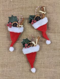 three red and white christmas decorations hanging on a burlock