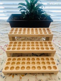 three tiered planter made out of plywood with holes on the bottom and sides