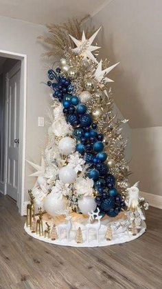 a decorated christmas tree with blue and white ornaments