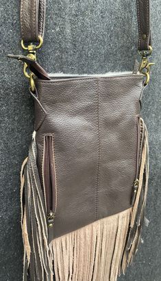 a brown purse with fringes hanging from it