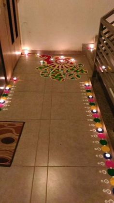 the floor is decorated with candles for diwali