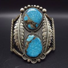 "VINTAGE NAVAJO BRACELET DESCRIPTION: This cuff features two gorgeous specimens of Apache Blue turquoise. The gemstones are secure in smooth bezel, on a foundation of heavy gauge vintage sterling silver. Twisted silver runs along the inside, and also bisects the bands of the cuff. Heavy and highly detailed applied leaves border the turquoise cabochons, This spectacular bracelet will be a cherished addition to your collection of fine vintage Native American jewelry. MEASUREMENTS: Interior of the Southwestern Blue Cuff Jewelry, Vintage Gemstone Cuff Bracelet Collectible, Blue Patina Bracelet Jewelry, Blue Patina Bracelet, Vintage Blue Cuff Jewelry, Blue Collectible Cuff Bracelet Bangle, Groovy Jewelry, Turquoise Jewelry Necklace, Bones Bracelet