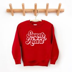 Looking for a cute sweatshirt for your kids? We have the perfect Sweet Heart With Heart graphic sweatshirt addition to their closet! Also available in toddler sweatshirts. Sweet Red Crew Neck Top, Playful Red Sweatshirt For Fall, Playful Red Cotton Sweatshirt, Cute Red Crew Neck Sweater, Cute Red Sweatshirt For Winter, Cute Red Winter Sweatshirt, Cute Sweatshirt With Heart Graphic And Crew Neck, Cute Crew Neck Sweatshirt With Heart Graphic, Cute Red Long Sleeve Sweatshirt