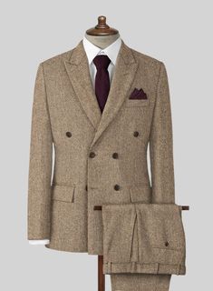 The Irish Brown Herringbone Tweed Suit will become the standard of business dressing and by far the most ubiquitous option. Crafted from wool, the Irish Brown color of the suit will surely influence a veteran dresser to buy the suit for building a sharp wardrobe. Team it up with a white shirt and dark brown derby shoes. 
 
 Look Includes  Irish Brown Herringbone Tweed Fabric  Double Breasted Jacket Style  Peak Lapel  Horn Brown Buttons  Single Vent  Three Cuff Buttons  Two Welted Back Pockets on Winter Tweed Three-piece Business Suit, Winter Business Tweed Three-piece Suit, Winter Tweed Three-piece Suit For Business, Tweed Three-piece Suit With Notch Lapel For Business, Winter Formal Tweed Three-piece Suit, Winter Tweed Three-piece Suit For Work, Tailored Herringbone Pattern Suits, Dapper Winter Wool Suit, Double-breasted Tweed Jacket For Business Casual