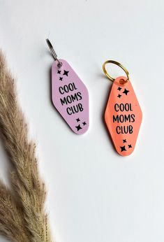 two keychains that say cool moms club and cool mom's club