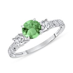 This Beautiful natural Emerald and diamond ring has just the right amount of sparkle. This ring consists of a 5mm Brilliant Round Cut Emerald center stone, surrounded by 0.58 ct. Brilliant Round Cut diamonds on a prong setting along each side of the band. Brilliant Round Cut Emerald Ring with Diamonds 0.58 ct. Item Features * New in box with tags * Metal Stamp: 14k, 18k, or Platinum * Gold: Yellow, White, and Rose * Natural Brilliant Round Cut Garnet * Center Stone: 5mm * Natural Brilliant Round Cut Diamonds * Total CTW Side Diamonds: 0.58 carats * Garnet Color: Medium * Clarity: Eye Clean * Diamond Color: H * Diamond Clarity:  SI1 Clarity * Setting Type: Shared-Prong * Ready to Ship in 3-7 Business Days * Handmade in USA ⦁Certificate of Appraisal is included with every purchase. ⦁Complime Diamond Ring With Prong Setting For May Birthstone, Emerald Promise Ring With Brilliant Cut, Brilliant Cut Emerald Promise Ring, Diamond May Birthstone Ring With Center Stone, Brilliant Cut Moissanite Emerald Ring For Promise, May Birthstone Diamond Ring In White Gold, Diamond Birthstone Ring With Center Stone For May, Solitaire Diamond Ring For May Birthstone, Brilliant Cut Promise Ring With May Birthstone