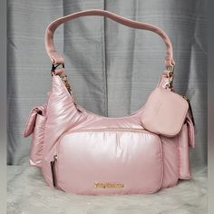 -Pink Pearl Hobo Shoulder Bag With "Juicy Couture" Logo Charm On The Front -Has Faux Leather Shoulder Strap -Bag Can Be Worn As A Shoulder Bag Or As A Handbag -Inside Bag Has One Zippered Wall Pocket With One Sleeve Pocket -Outside Has A Sleeve Magnetic Snap Closure Pocket On Each Side And One Zippered Wall Pocket On The Front -Comes With Faux Leather Zippered Pouch -Zippered Closure -Gold Hardware Accents -New With Tags. No Damages Dimensions: W:11½" H:8¼" D:3½" Pink Hobo Bag With Zipper Closure, Pink Hobo Bag With Zipper Closure For Shopping, Pink Crossbody Hobo Bag With Zipper, Pink Crossbody Bag With Zipper Closure, Pink Hobo Bag With Removable Pouch For Travel, Pink Hobo Bag With Zipper For Travel, Pink Hobo Bag For Travel With Zipper Closure, Juicy Couture Logo, Leather Zipper Pouch