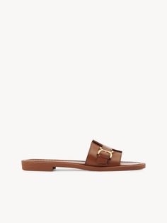 Chloé Marcie Slide | Chloé US Spring Leather Sandals With Gold Buckle, Summer Leather Slides With Gold Buckle, Elegant Flat Slides For Formal Occasions, Elegant Gold Leather Slides, Elegant Formal Flat Slides, Classic Flat Slides With Buckle Closure, Elegant Mules With Buckle Closure In Slide Style, Elegant Slide Mules With Buckle Closure, Elegant Gold Flat Slides