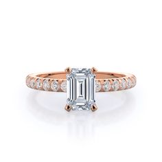 an emerald - cut diamond engagement ring set in 18k rose gold with side stones