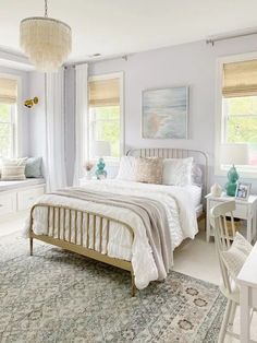 a bedroom with white furniture and blue walls