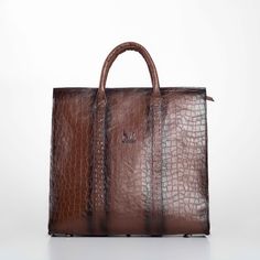 Elevate your professional ensemble with our Handmade Brown Leather Business XL Bag, a perfect blend of luxury and functionality for the modern man. Expertly crafted from premium genuine leather, this bag features an elegant embossed pattern that exudes sophistication. The interior is lined with durable gabardine fabric, while sleek black nickel metallic elements add a contemporary touch. Designed with practicality in mind, this spacious bag includes an internal zippered pocket, a dedicated laptop compartment, and a leather mobile phone holder, ensuring all your essentials are organized and secure. The long, adjustable strap with broad padding offers comfort, making it ideal for daily business use or travel. Key Features: Sophisticated Design: Crafted from high-quality genuine leather with Designer Formal Bags With Large Capacity, Designer Large Capacity Formal Bags, Leather Lined Tote Bag For Business Trips, High-end Business Shoulder Bag With Leather Lining, Elegant Textured Leather Shoulder Bag Briefcase, Elegant Textured Leather Briefcase With Double Handle, Elegant Large Capacity Shoulder Bag For Business Trips, High-end Leather Bags With Large Capacity, Formal Textured Leather Tote Bag