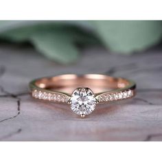 a rose gold engagement ring with diamonds on it