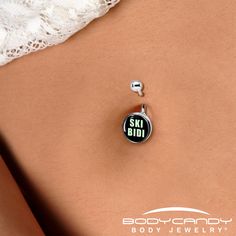 a woman's stomach with a black and white badge on it that says ski bid