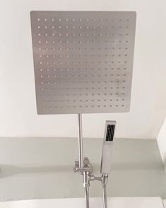 a bathroom faucet with a square shaped shower head