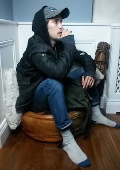 a man sitting on top of a bean bag chair