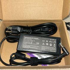 an open box with a power cord and charger in it