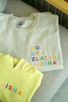 Celebrate motherhood with our cozy embroidered Mama Sweatshirt, personalized with your kids' names. Perfect for twin moms, boy moms, girl moms and every loving momma, this sweatshirt makes a thoughtful gift for any occasion. Whether you're a proud twin mom or simply want to cherish your little ones, this sweatshirt is the perfect way to keep them close to your heart. To receive your Sweatshirt in Gift Packaging: 1. Add the Sweatshirt you want to your cart 2. Add the Gift box in the appropriate s Custom Embroidered White Tops For Mother's Day, White Family Matching Sweatshirt With Letter Embroidery, Family Matching White Sweatshirt With Letter Embroidery, Embroidered Cotton Short Sleeve Sweatshirt, Personalized Cotton Crew Neck Sweatshirt, Personalized Cotton T-shirt, Family Matching Cotton Tops With Custom Embroidery, Customizable Family Matching Cotton Sweatshirt, Cotton Sweatshirt With Multicolor Embroidered Text