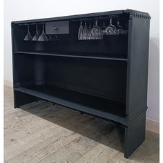 a black cabinet with wine glasses on it