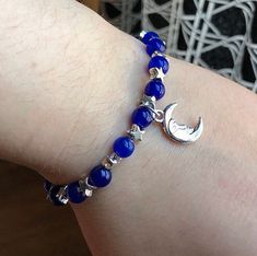 This is a beautiful celestial bracelet with deep blue glass beads, silver stars and a silver crescent moon charm. The charm is the same on both sides. Silver Bracelets With Moon Charm And Round Beads, Silver Bracelet With Moon Charm And Round Beads, Silver Beaded Bracelets With Moon Charm As Gift, Glass Beads Bracelet Ideas, Witches Road, Beaded Bracelet Diy, Celestial Bracelet, Celestial Stars, Bracelet Diy