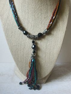 Vintage 20" Necklace, Colorful Glass Beads, Silver Tone Bali Style Accents, 4" Long Tassel 020521 Glass beads in iridescent colors Previously owned and In very good Vintage condition. Please, contact us if you any questions. Beautiful necklace! Please see my other listings for more vintage jewelry- I am happy to combine the shipping. Thanks so much!  Beautiful necklace! Please see my other listings for more vintage jewelry- I am happy to combine the shipping. Thanks so much! Necklace Colorful, Bali Style, Bali Fashion, Colourful Necklace, Beautiful Necklace, Columbus, Colored Glass, Tassel Necklace, Beautiful Necklaces