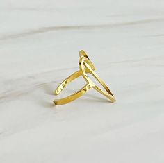 Introducing the Open Heart Lovely Ring, a stylish accessory with a simple and lovely open heart design. Made with precision and care, this ring is the perfect addition to any outfit. Express your love and style with this beautiful piece. Dimensions: approximately 1” x 1” x 1” 18k gold plated stainless steel, tarnish and water resistant Lead and Nickel free Gold Plated Open Band Midi Rings As Gift, Chic Gold Midi Rings For Gift, Adjustable Gold Heart-shaped Initial Ring, Gold Open Heart Ring Gift, Adjustable Gold Heart Initial Ring, Gold Plated Open Ring Midi Rings With Simple Design, Gold Minimalist Bypass Promise Ring, Gold Plated Open Midi Rings With Simple Design, Elegant Gold Open Circle Midi Rings