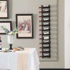 there is a wine rack on the wall next to a table with two bottles of wine