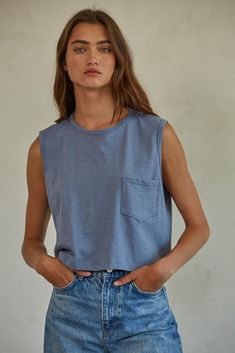 Elevate your basics with our Leah Tee. Made from soft knit cotton jersey, this sleeveless tank top features a round neck and convenient front pocket. Perfect for casual days or layering under a jacket. Say hello to your new go-to piece! Spring Tees, Jersey Tank Top, Loungewear Sets, Cardigan Top, Dress Gift, Knit Cotton, Sleeveless Tank Top, Swimwear Accessories, Sleeveless Tank