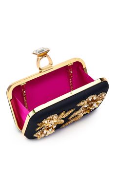 She’s definitely more than a friendship ring. She’s, as they say, “A Rock.” The full-framed convertible clutch, complete with a gold-tone finish and a removable chain, is sure to impress with its faceted step-cut crystal embellishment. From date night to gala season and everything in between, this piece will be your new best (and sparkliest) friend.Details:7.68" L X 2.36" W X 4.9" HClasp ClosureOuter: Duchess SatinInner: Satin LiningMetal Chain included with 20" Drop for Shoulder or Crossbody we Latest Clothing Trends, Friendship Ring, Sachin Babi, Embellished Clutch, Duchess Satin, Friendship Rings, Step Cut, Special Occasion Outfits, On The Rocks