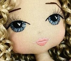 a doll with curly hair and blue eyes