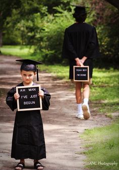 a young boy wearing a graduation gown and holding a sign that says i've just begun