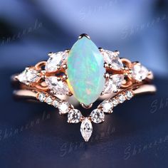 an opal and diamond ring on a blue background