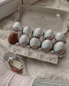 a dozen eggs are in an egg carton on a bed next to a bottle of milk