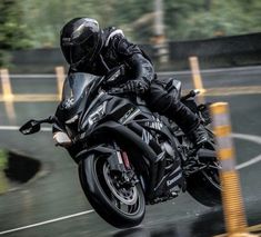 a man riding on the back of a black motorcycle