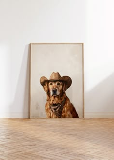 a dog wearing a cowboy hat sitting in front of a painting on the wall next to a wooden floor