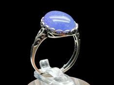 Elevate your style and energy with this exquisite Tanzanite Crystal Ring, a unique and adjustable piece of high-quality gemstone jewelry. The ring is as unique as you are, and you will receive the exact piece you see in the pictures and video. Discover the extraordinary healing properties of tanzanite while adorning your fingers with a true work of art. Key Features: Genuine Tanzanite: Our rings are crafted with high-quality, genuine tanzanite crystals, known for their stunning violet-blue hues and exceptional energy. Tanzanite is believed to hold powerful healing properties, making it an excellent choice for those seeking a spiritual connection. Adjustable Size: The adjustable design allows for a comfortable fit on most fingers, making it a versatile and convenient accessory for daily wea Elegant Adjustable Moonstone Ring For Healing, Adjustable Fine Jewelry Moonstone Ring, Adjustable Moonstone Ring In Fine Jewelry Style, Adjustable Opal Ring With Natural Stones, Unique Adjustable Ring With Round Stone, Unique Adjustable Rings With Round Stone, Adjustable Chalcedony Jewelry For Anniversary, Adjustable Spiritual Crystal Ring With Large Stone, Elegant Birthstone Rings For Healing