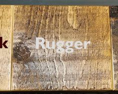 two pieces of wood with the word rugger written on them