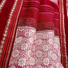 Explore the beauty of traditional handwoven korvai kanjivaram silk saree. Crafted by hand block printed with azo-free dyes, this saree features a white base with pink floral body with red border and pallu. Accented with hand screen print, this elegant piece will make a timeless addition to your wardrobe. Approximate Length 6.5 mtrs (inclusive of blouse length) Approximate Height - 46 - 50" Approximate weight - 1.7 lbs Saree comes with fall, picot and tassels done when applicable. Blouse piece is cut. Kindly Note : The colors you see on your device may vary due to the color reproduction, brightness and resolution of individual devices. If you'd like more clarity before your purchase, please contact our support team. Pink Block Print Traditional Wear For Puja, Pink Block Print Traditional Wear For Festivals, Traditional Pink Block Print Wear For Festivals, Pink Block Print Traditional Wear, Festival Pink Traditional Wear With Block Print, Pink Dupatta With Block Print In Traditional Drape, Traditional Pink Saree With Block Print, Pink Chanderi Traditional Wear With Block Print, White Cotton Silk Dupatta With Block Print