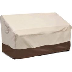 an outdoor furniture cover with brown and white trimmings on the top, sitting in front of a white background