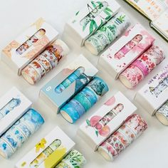 several rolls of japanese washi tape are arranged on a white surface with various designs and colors