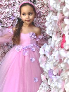 Introducing the enchanting Sanjana Flower Girl Tulle Dress, a masterpiece from Blush Kids that merges fairy-tale elegance with contemporary charm, and it comes with Free Shipping! This exquisite dress features a luxurious satin bodice that gently hugs the silhouette, leading to a romantic sweetheart neckline that captivates at first glance. The magic doesn't end there; Victorian long tulle sleeves drape gracefully, adding a touch of old-world glamour and mystery to the ensemble. But the true all Flower Girl Tulle Dress, Baby Christening Outfit, Girls Communion Dresses, Flower Girl Wedding, Girls Tulle Dress, Girls Crown, Princess Flower, Flower Girl Crown, Tulle Sleeves