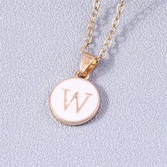 Add a personalized touch to your look with our YourLetter White Enamel Circle Necklace. Crafted with a white enamel background and gold color detailing, the necklace comes with a choice of single letter pendant. A great way to show off your initials or those of someone you love. Gold Initial Pendant Necklace With Letter Print, Minimalist White Jewelry With Initial Pendant, White Initial Pendant Necklace With Monogram, White Monogram Initial Pendant Necklace, White Monogram Initial Necklace, White Minimalist Initial Pendant Necklace, Personalized White Initial Pendant Necklace, Personalized Gold Enamel Charm Necklace, Minimalist White Initial Necklace