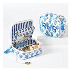 two blue and white suitcases with the initials r & f on them, one is filled with money