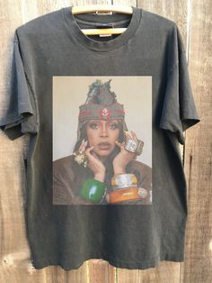 Retro Erykah Badu Country Music Shirt, Erykah Badu Albums Graphic shirt,Erykah Badu Tour 2023 Shirt, Gift for Men Women Unisex T-Shirt : 100% Cotton (fiber content may vary for different colors) .: Medium fabric (5.3 oz/yd² (180 g/m .: Classic fit .: Runs true to size HOW TO ORDER Pick you favorite design. Review the size & color charts above FIRST and then select shirt size and color from the dropdown menu. Indicate the birthday year in the personalization box. Please note size measurements for Festival Graphic Print Relaxed Fit T-shirt, Festival Streetwear Crew Neck T-shirt, Cotton T-shirt For Festival Streetwear, Festival Graphic Crew Neck Top, Relaxed Fit Crew Neck T-shirt For Festivals, Festival Graphic Print Crew Neck T-shirt, Festival Crew Neck Top With Graphic Print, Festival Graphic Print Crew Neck Top, Graphic Print Crew Neck Top For Festival