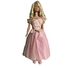 the barbie doll is wearing a pink dress