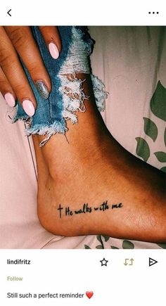 a woman's foot with a tattoo saying, i am the walk with me