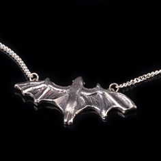 "Flying fruit bat silver pendant with silver chain. Bat gothic jewelry as a gothic gift. It is also a halloween witch necklace. This bat pendant was carved in wax and was casted in solid Sterling Silver. Size and details: Bat pendant length: 1.7\" inches (4.4 cm) Bat pendant width: 0.8\" inches (2.2 cm) Sterling silver curb chain lengths: 16\" ,17\", 18\", 19\", 20\" inches All my jewelry are handmade by me and inspired from my love to animals and nature and ancient cultures. My designs are pack Gothic Hand-cast Halloween Necklaces, Halloween Engraved Sterling Silver Necklaces, Halloween Sterling Silver Pendant Necklace, Nautical Ring, Bat Pendant, Bat Jewelry, Bat Necklace, Witch Rings, Mushroom Ring