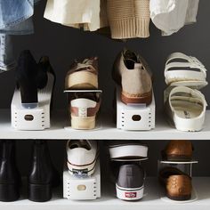 several pairs of shoes are lined up on shelves