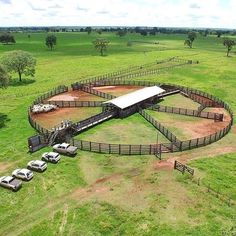 an aerial view of a farm with cars parked in it